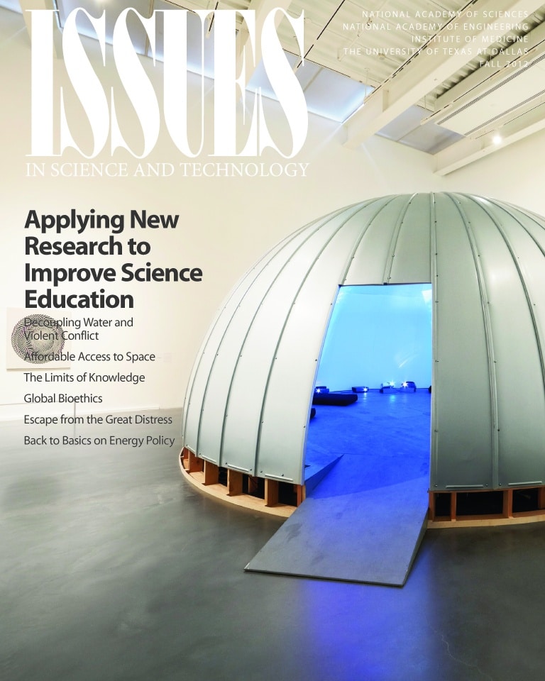 Magazine cover shows a metal hut with projectors inside