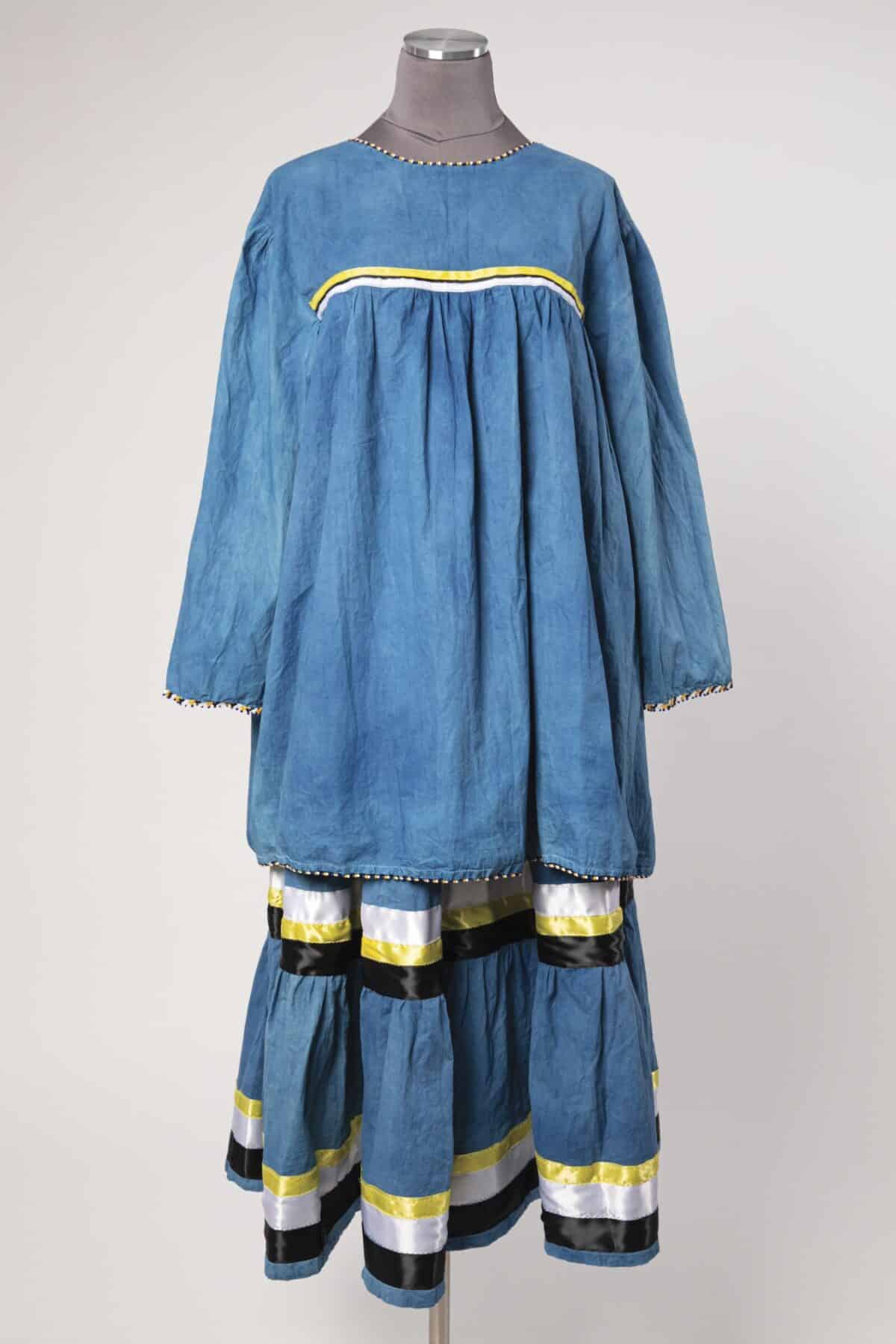LouAnn Moses, Coco Tribe of Canneci Tinne, Canneci Apache Camp Dress, 2024. Muslin fabric, glass beads, ribbons, dyed with indigo plants, 69 x 67 in. Collection of LouAnn Moses, Coco Tribe of Canneci Tinne. Photograph by Ron Kerner.